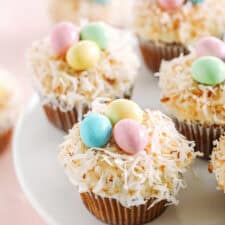 Celebrate Easter with these festive Bird's Nest Carrot Cake Cupcakes that are super moist, naturally sweetened with maple syrup and applesauce, all topped with a cream cheese frosting, toasted coconut and chocolate candies! 
