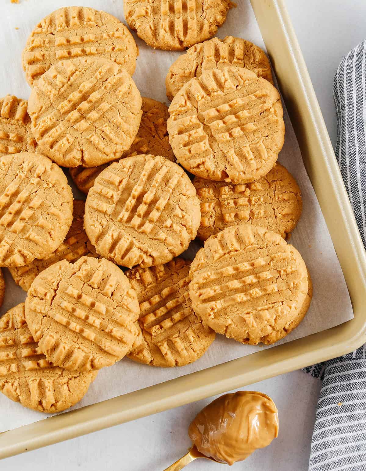 The BEST 5-Ingredient Peanut Butter Cookies recipe made with simple pantry ingredients and zero flour, butter or oil!  Soft, chewy cookies with rich peanut butter flavor are the perfect gluten-free sweet treat.