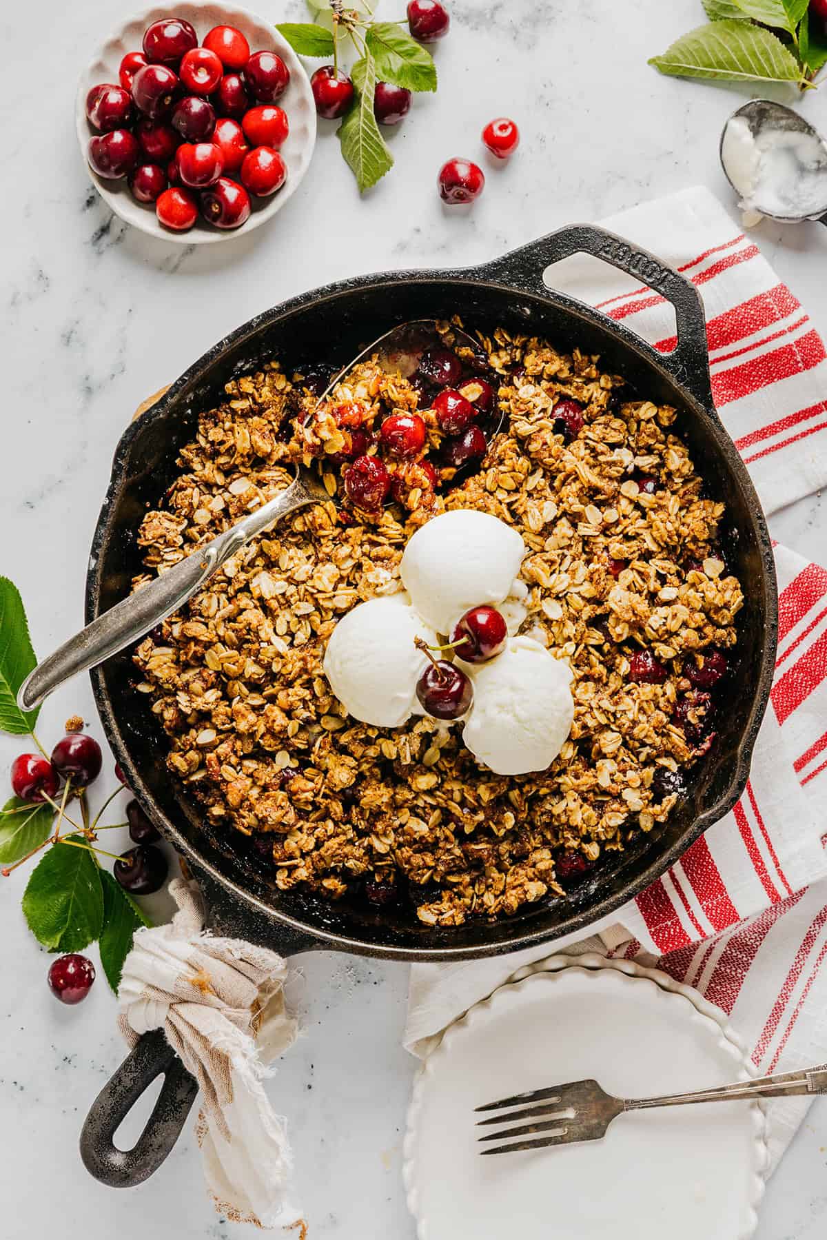 This Healthy Cherry Crisp is the ultimate summer dessert! Bursting with sweet cherries and a wholesome oat topping, this warm cherry crisp easily comes together with just a few simple ingredients!