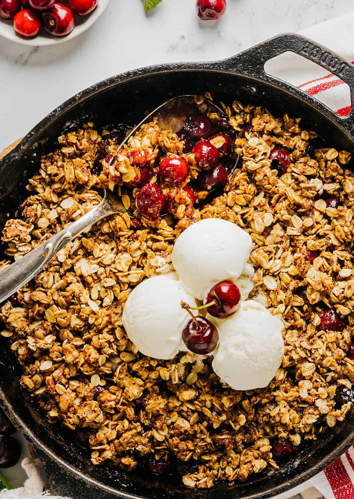 This Healthy Cherry Crisp recipe is the ultimate summer dessert! Bursting with sweet cherries and a wholesome oat topping, this warm cherry crisp easily comes together with just a few simple ingredients!