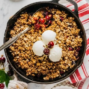 This Healthy Cherry Crisp is the ultimate summer dessert! Bursting with sweet cherries and a wholesome oat topping, this warm cherry crisp easily comes together with just a few simple ingredients!