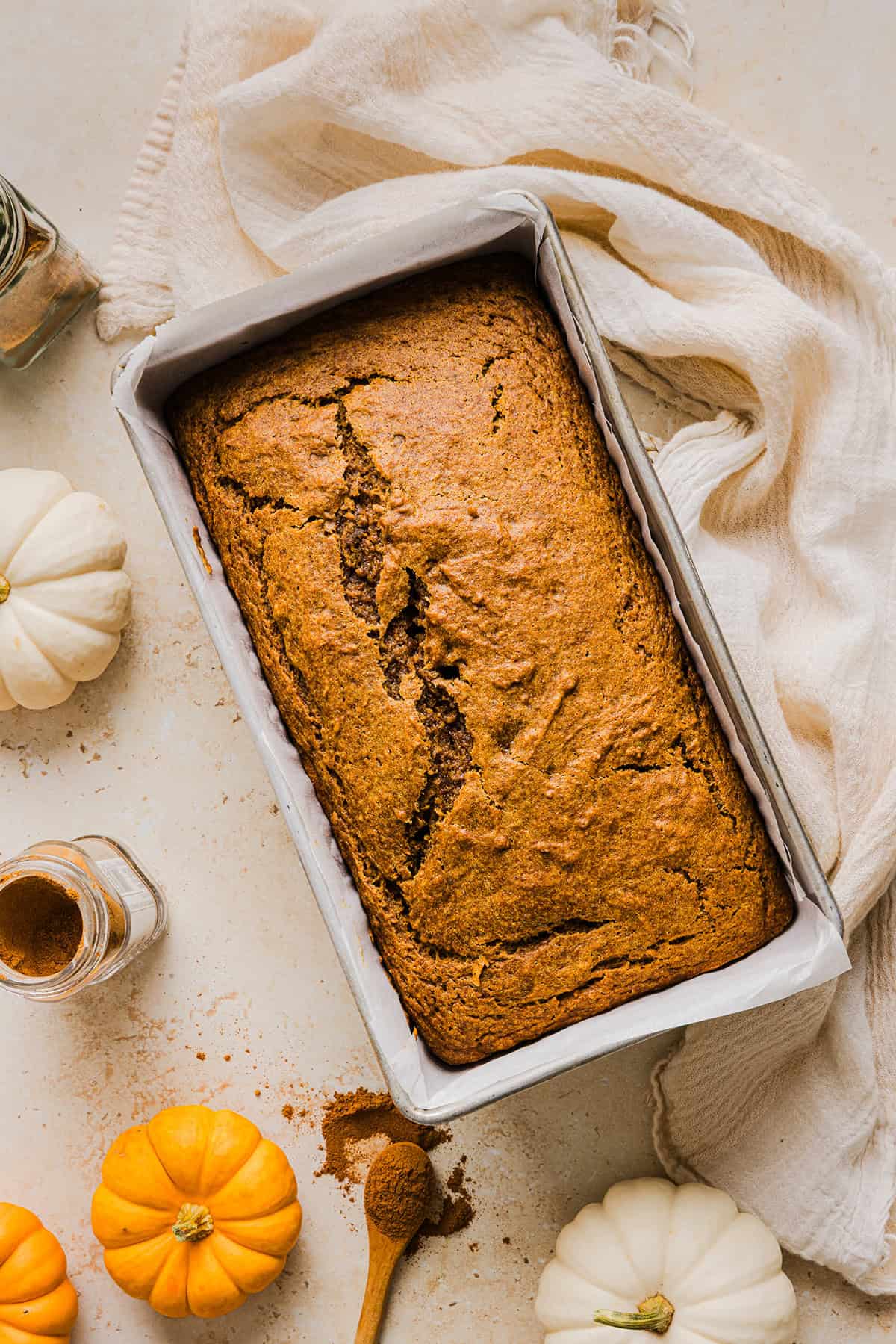 The BEST Healthy Pumpkin Bread that is moist, loaded with pumpkin flavor and made without any butter or refined sugar! Topped with a delicious maple cream cheese glaze for the perfect fall treat this season!