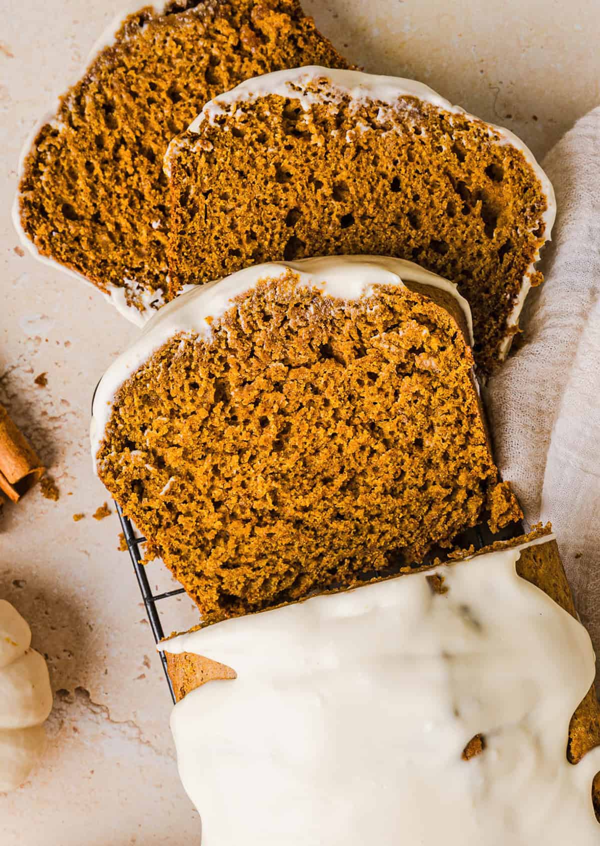 The BEST Healthy Pumpkin Bread that is moist, loaded with pumpkin flavor and made without any butter or refined sugar! Topped with a delicious maple cream cheese glaze for the perfect fall treat this season!