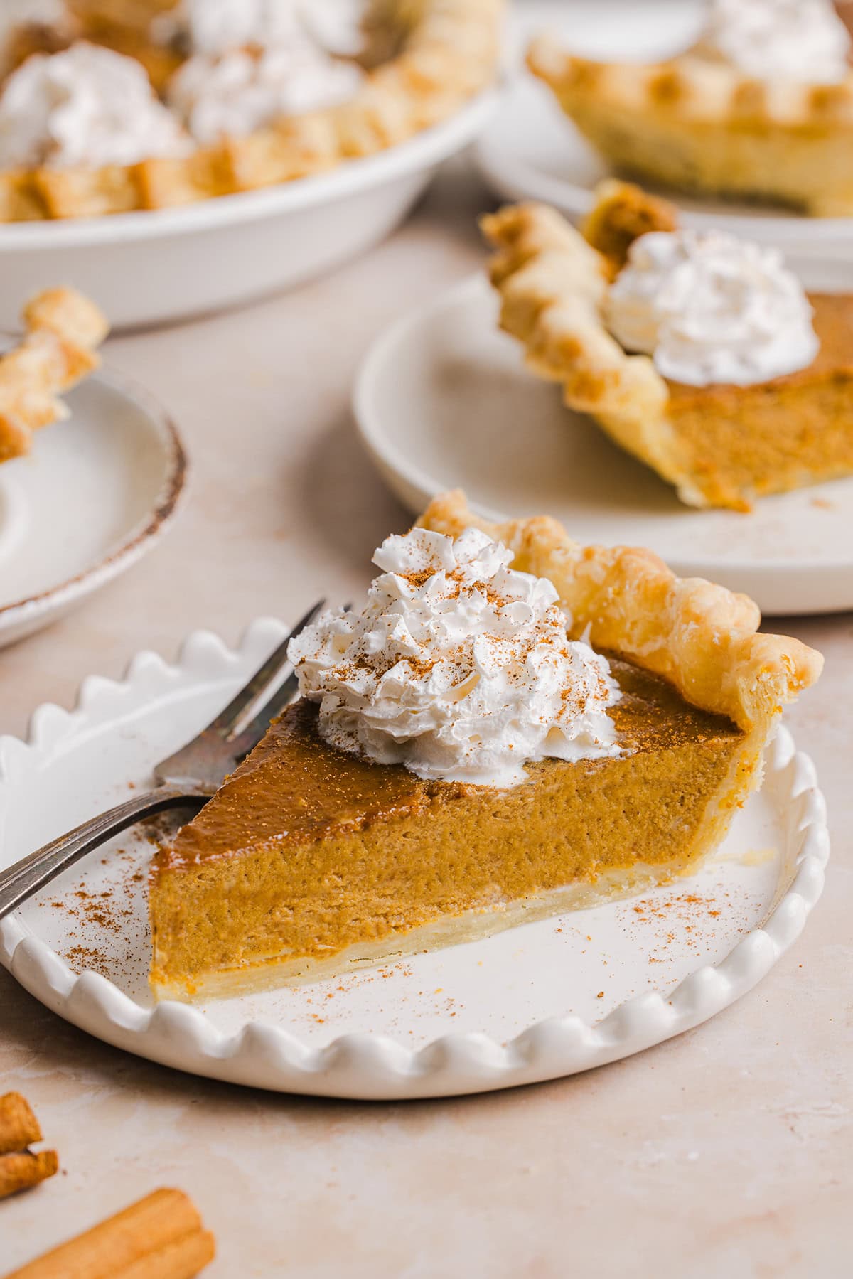 This creamy and delicious Healthy Pumpkin Pie makes the perfect holiday dessert! So easy to make, naturally sweetened with maple syrup and tastes great topped with whipped cream or vanilla ice cream!