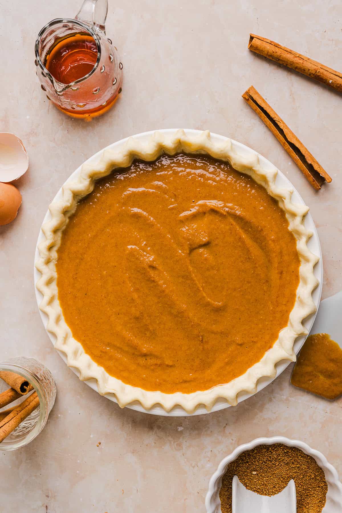 This creamy and delicious Healthy Pumpkin Pie makes the perfect holiday dessert! So easy to make, naturally sweetened with maple syrup and tastes great topped with whipped cream or vanilla ice cream!