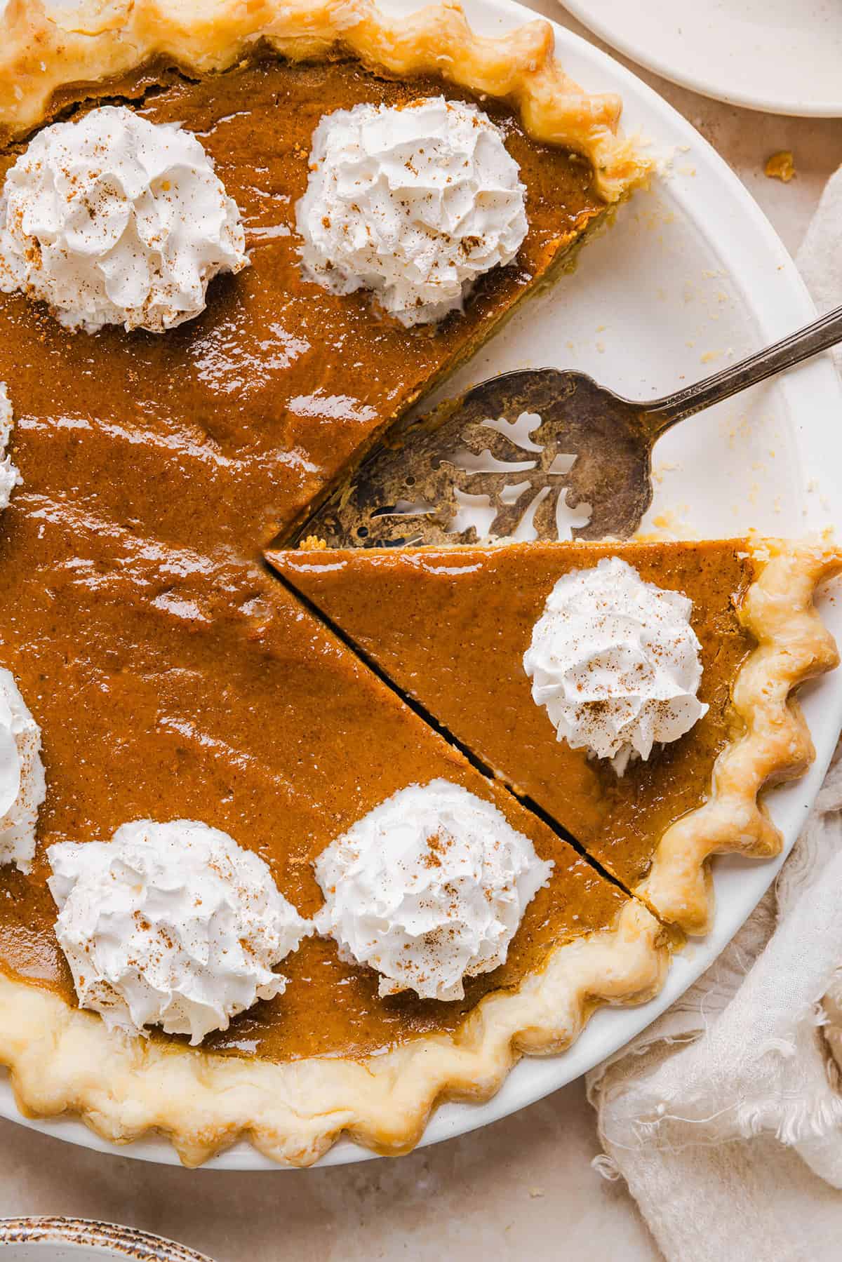 This creamy and delicious Healthy Pumpkin Pie makes the perfect holiday dessert! So easy to make, naturally sweetened with maple syrup and tastes great topped with whipped cream or vanilla ice cream!